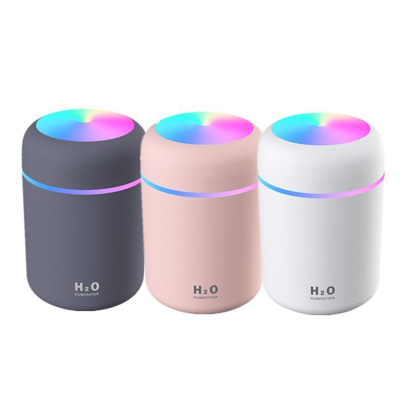Portable USB car humidifier and essential oil diffuser emitting cool mist on a desk — view 2