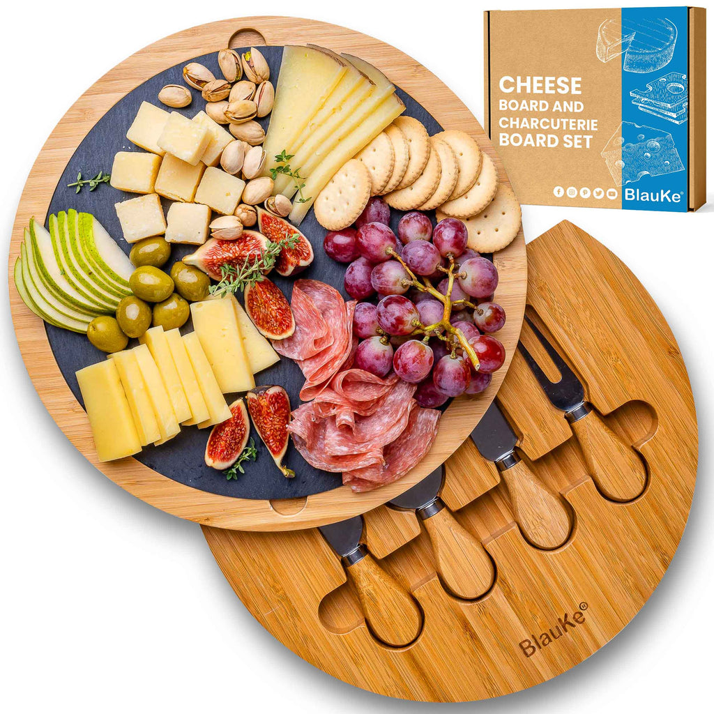 Round bamboo cheese board with removable slate, hidden drawer, and four stainless steel serving knives.