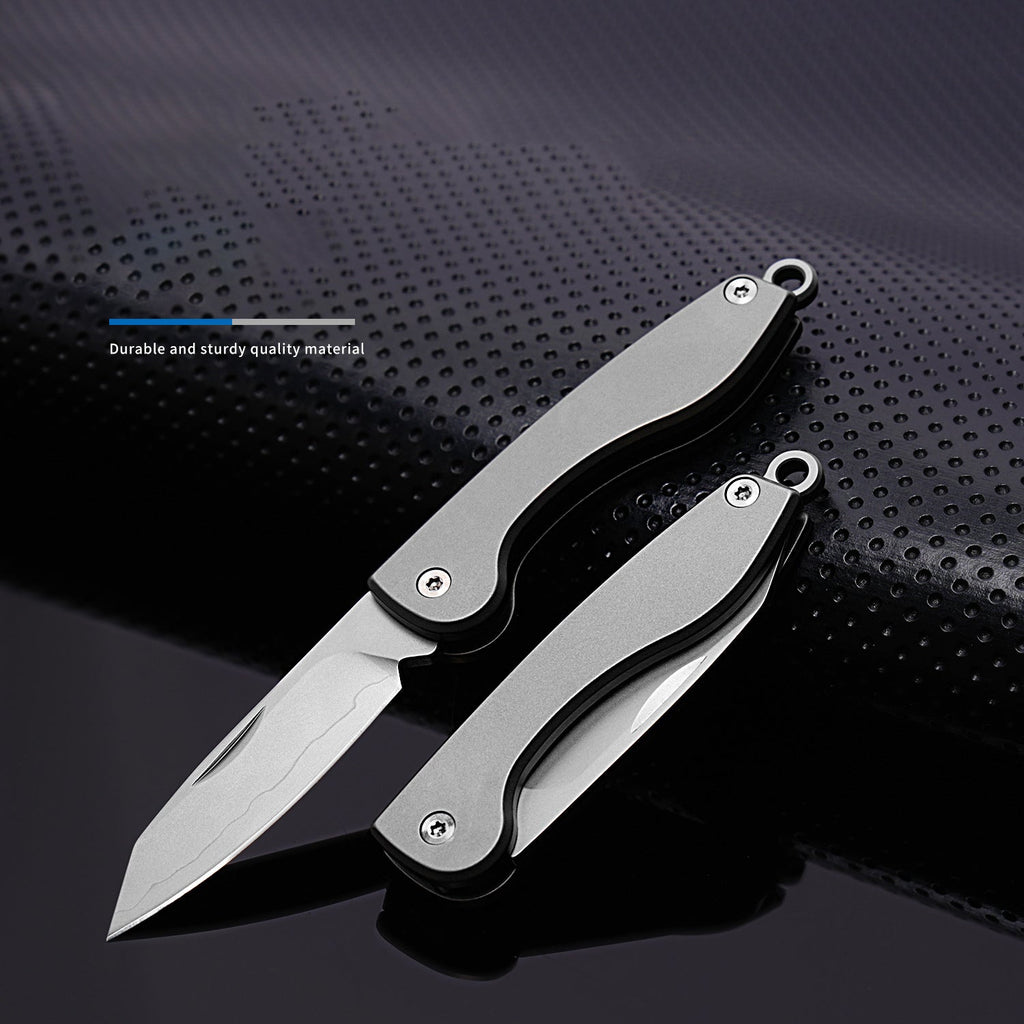 Mini folding titanium utility knife with a razor-sharp stainless steel blade and compact keychain loop — view 2
