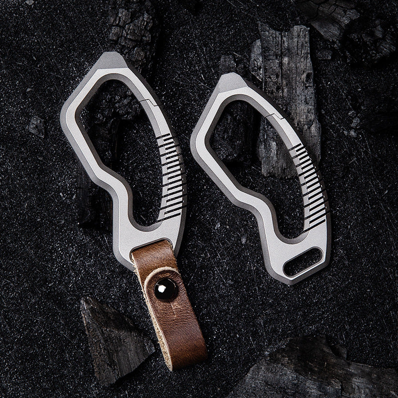Titanium alloy keychain with genuine leather accents and sleek side-push locking mechanism