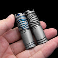 Titanium EDC flashlight, compact silver handheld LED torch for outdoor camping and everyday carry.