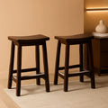 Set of two solid wood saddle seat counter stools in a rich dark walnut finish