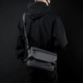 Black water-resistant minimalist men's messenger bag with adjustable shoulder strap and sleek flap design.