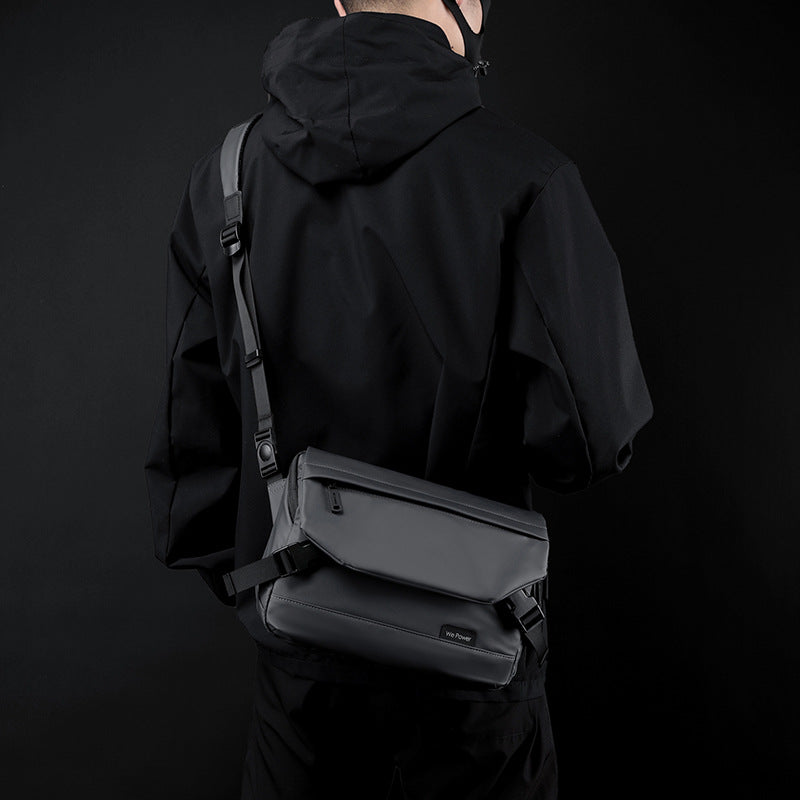 Black water-resistant minimalist men's messenger bag with adjustable shoulder strap and sleek flap design.