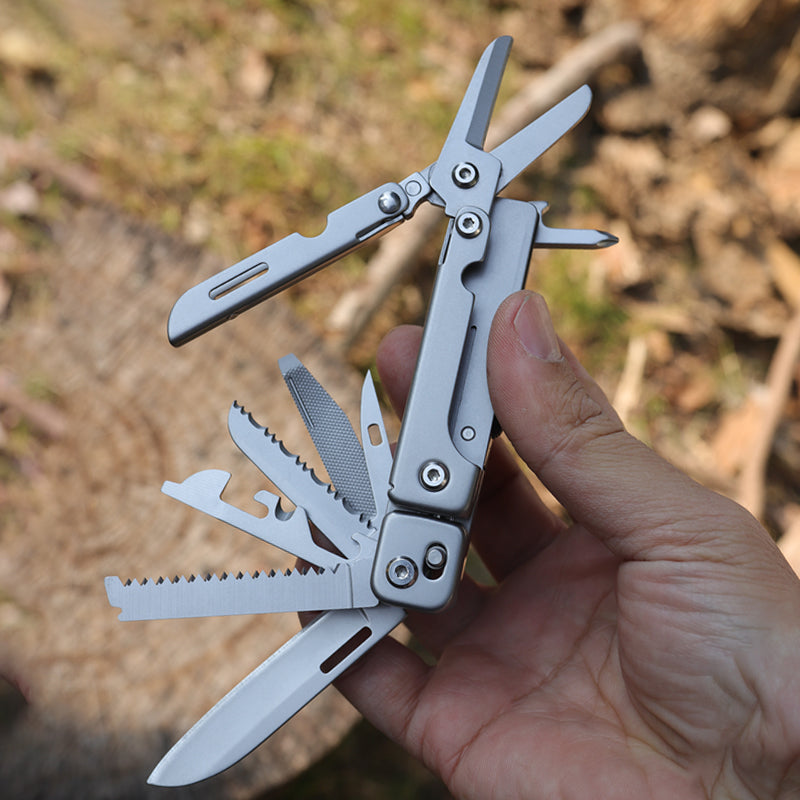 Stainless steel folding pocket multitool pliers with keychain attachment, featuring various extended functional tool blades — view 3