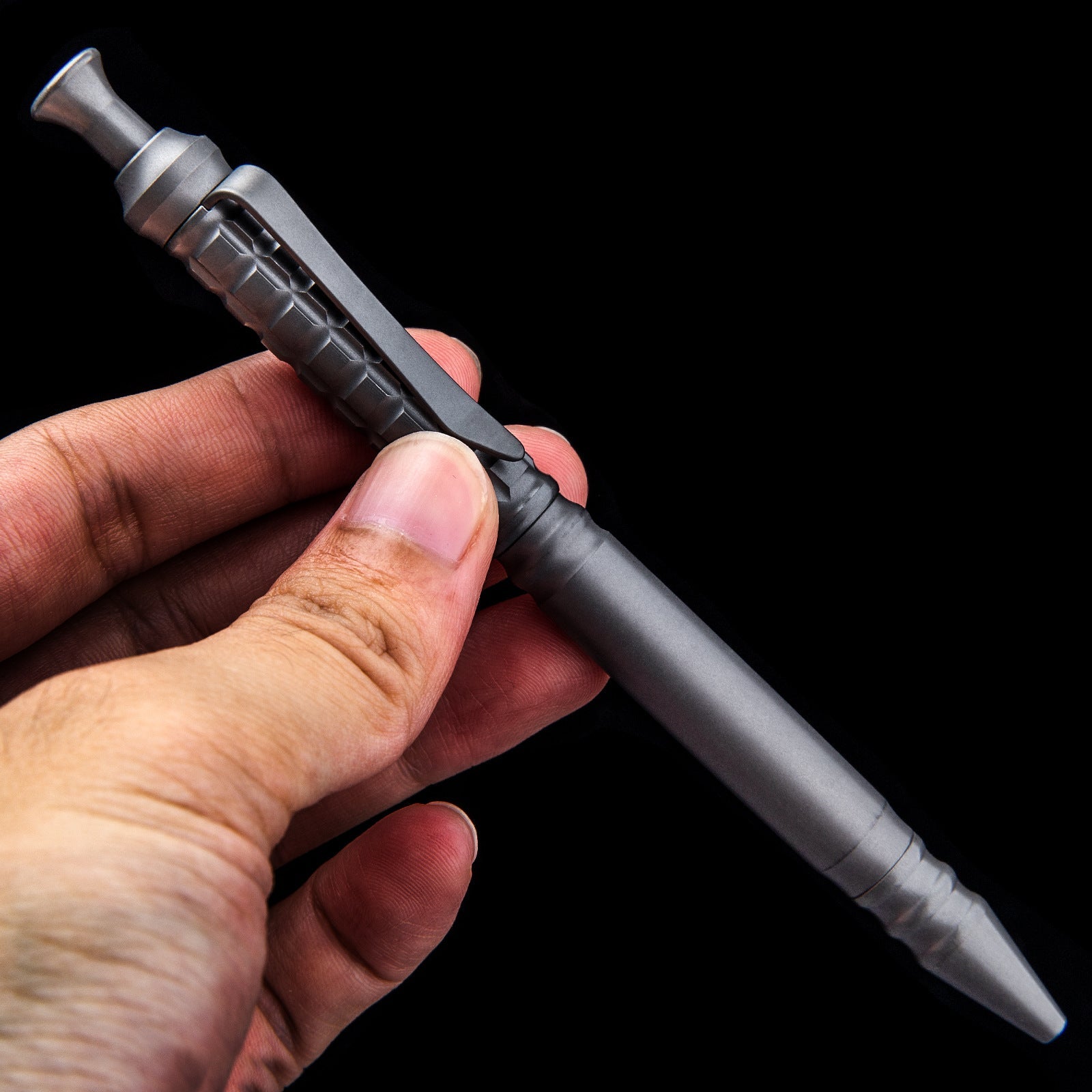 Compact titanium tactical pen with pocket clip and textured anti-slip grip for everyday carry — view 3