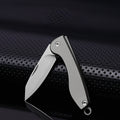 Mini folding titanium utility knife with a razor-sharp stainless steel blade and compact keychain loop