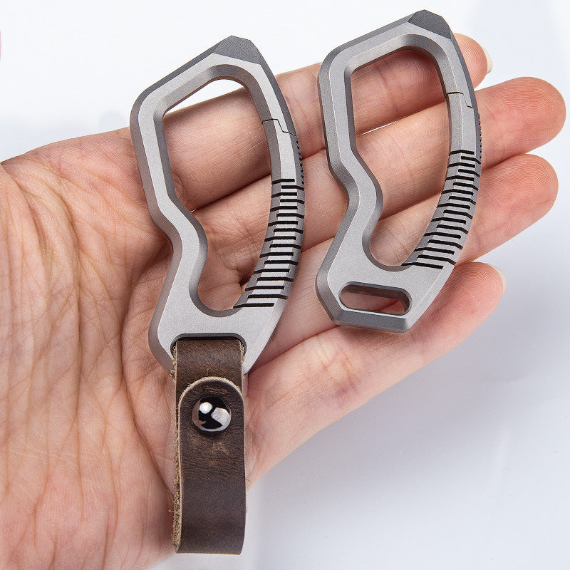 Titanium alloy keychain with genuine leather accents and sleek side-push locking mechanism — view 4