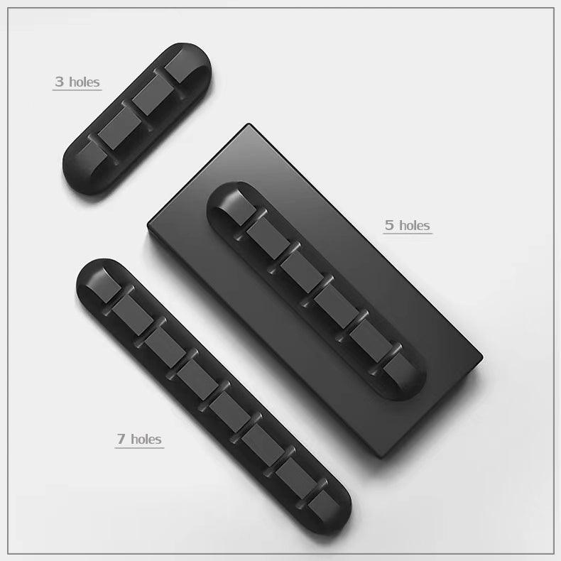 Silicone desk cable organizer clips holding various USB and charging cords on a flat surface — view 5