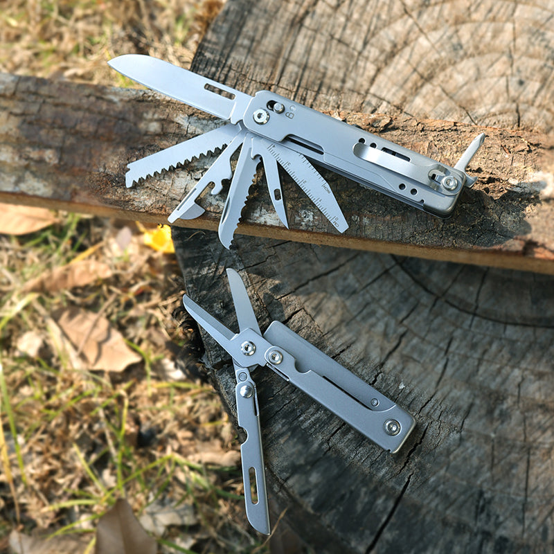 Stainless steel folding pocket multitool pliers with keychain attachment, featuring various extended functional tool blades