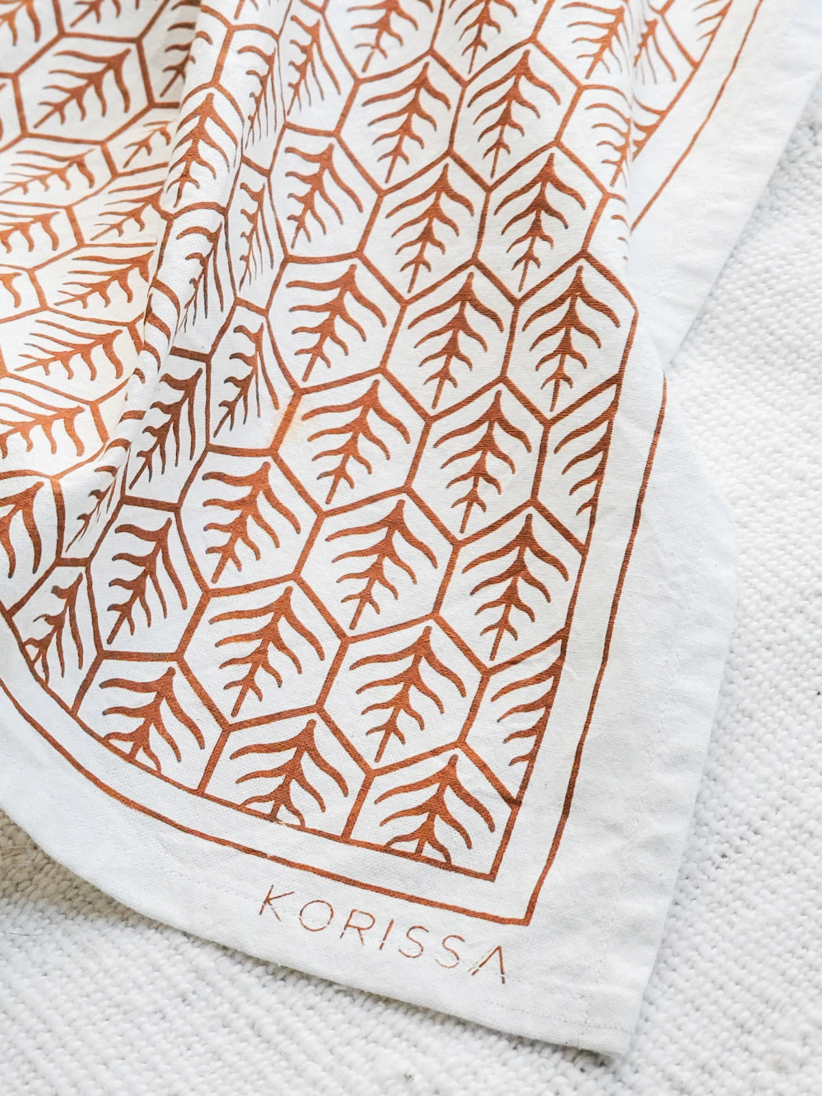 Hand screen-printed tea towel in natural white cotton with brown earthy artisan design patterns — view 5