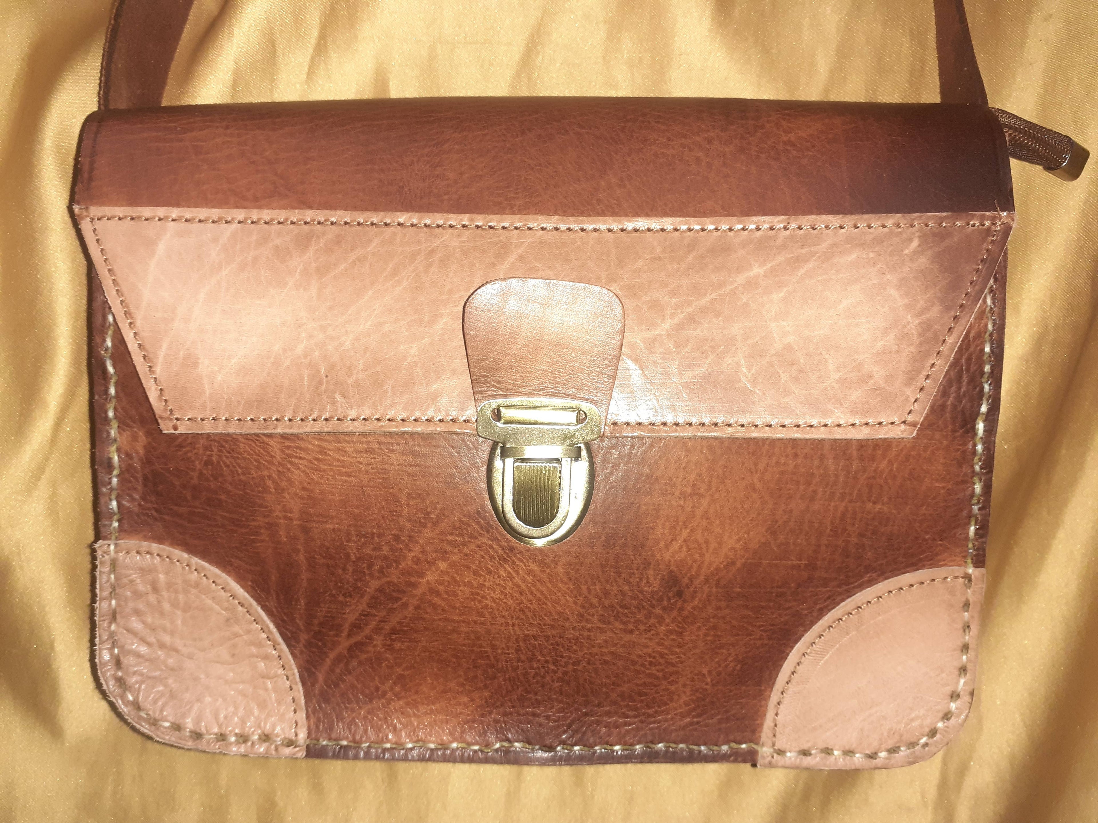 Two-tone leather crossbody bag with rustic finish, front zipper pocket, and long adjustable shoulder strap — view 6