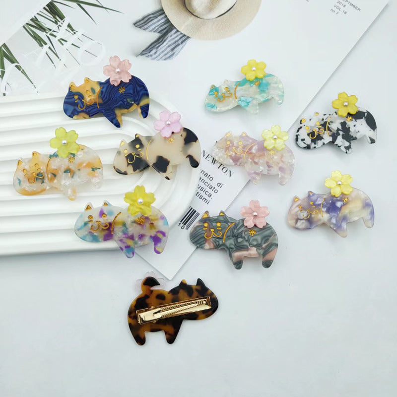 Hand-painted floral cat hair clip in eco-friendly cellulose acetate with glass rhinestones and alligator grip