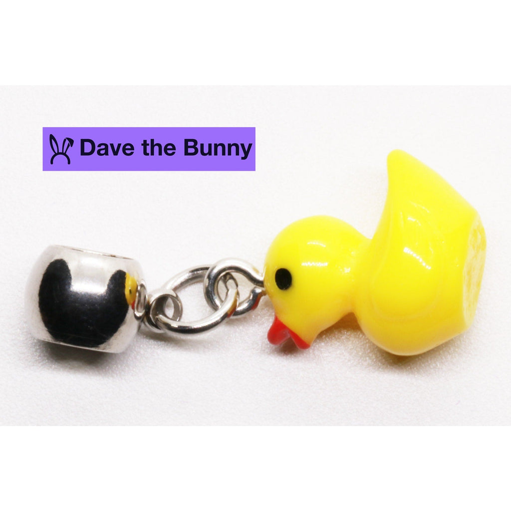 Yellow rubber duck pendant necklace on a polished silver tone chain with purple gift pouch — view 5