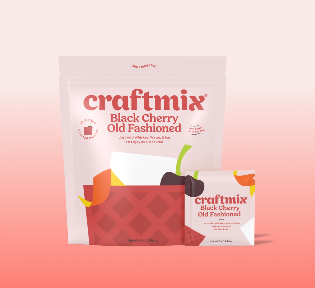 Black cherry old fashioned cocktail mix packet with a dark red drink over ice