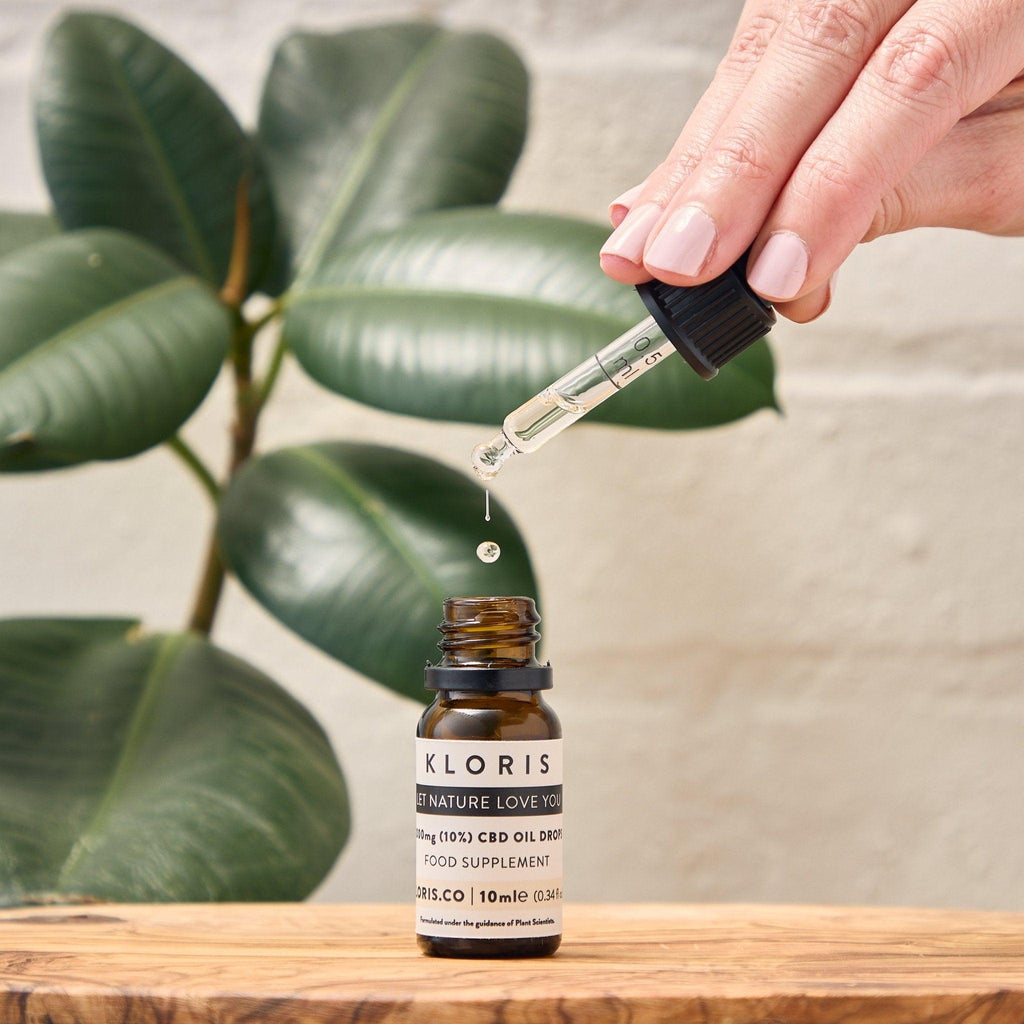 Bottle of 1000mg broad spectrum CBD oil drops with glass dropper on white background — view 2