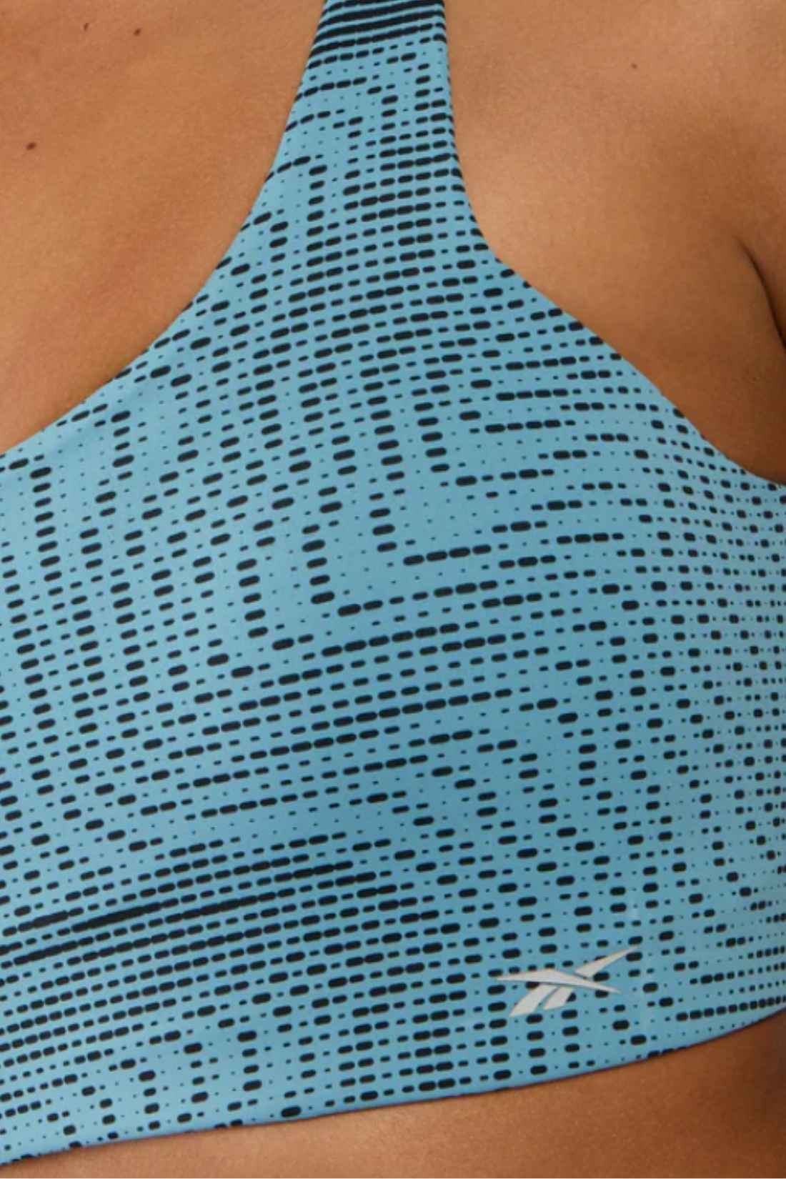 Light blue patterned nylon women's running sports bra with adjustable straps and rowing style back — view 12