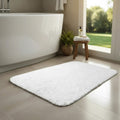 100 percent cotton tufted bath rug with a vintage fringe texture on a bathroom floor