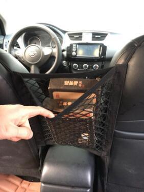 Black polyester universal car seat storage net and pet barrier suspended between two front seats — view 2