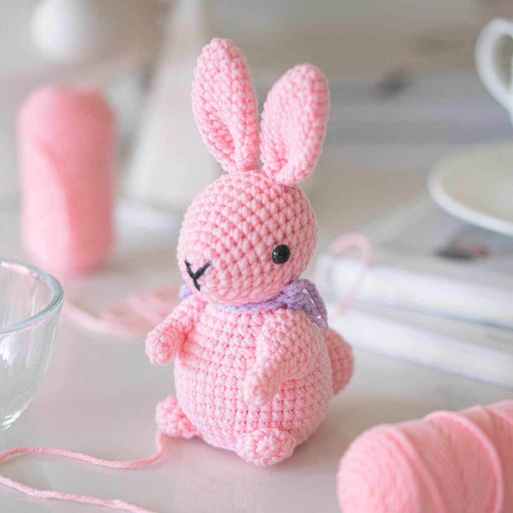 Rabbit amigurumi crochet kit showing finished plush bunny, premium threads, hook, and instructions — view 3