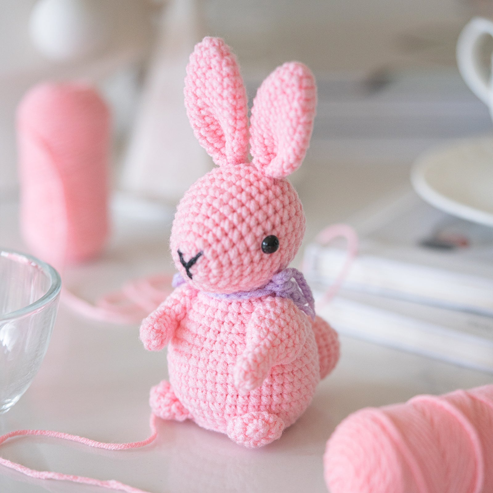 Rabbit amigurumi crochet kit showing finished plush bunny, premium threads, hook, and instructions — view 3