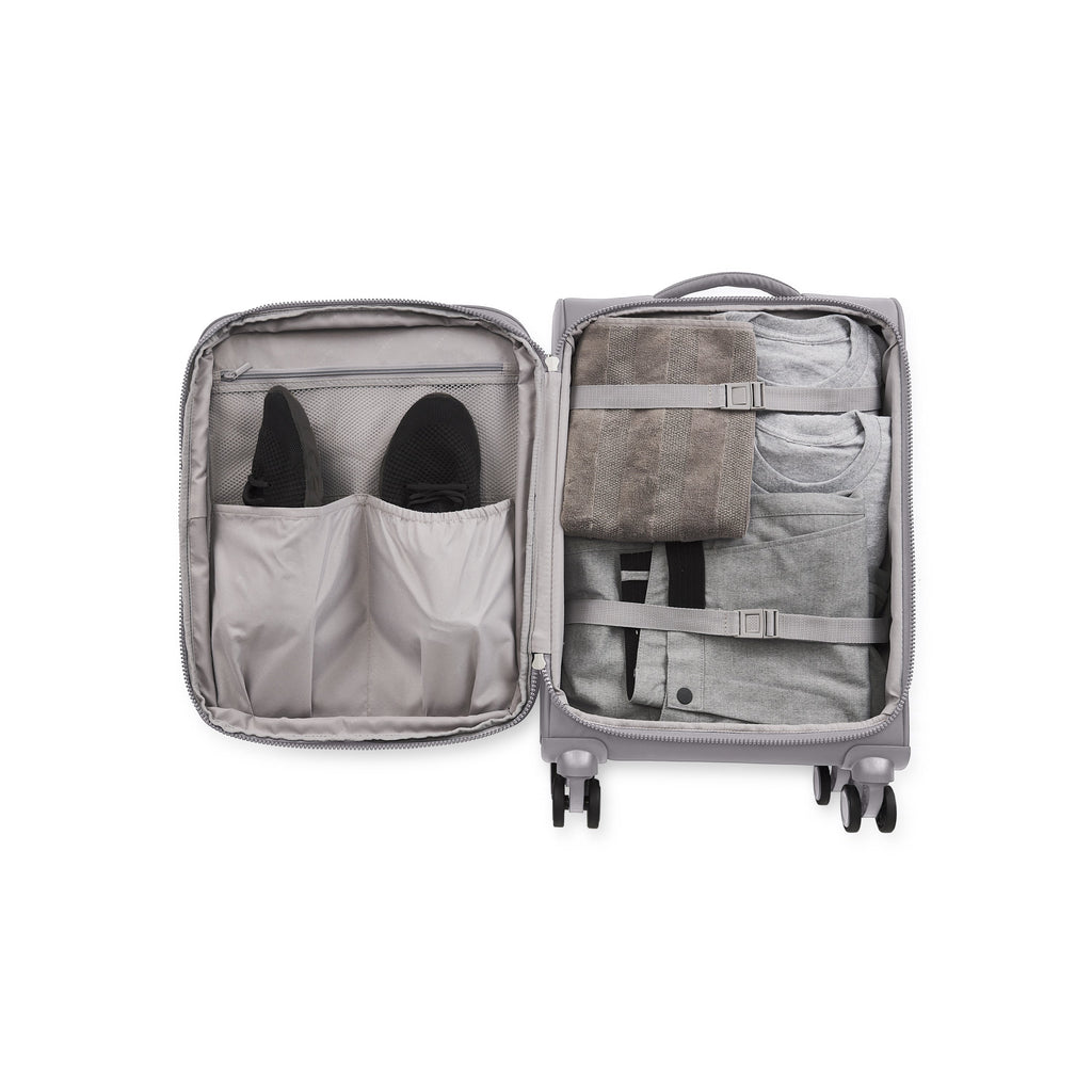 Amsterdam carry-on suitcase in sleek black featuring multi-directional spinner wheels and a telescopic handle — view 4