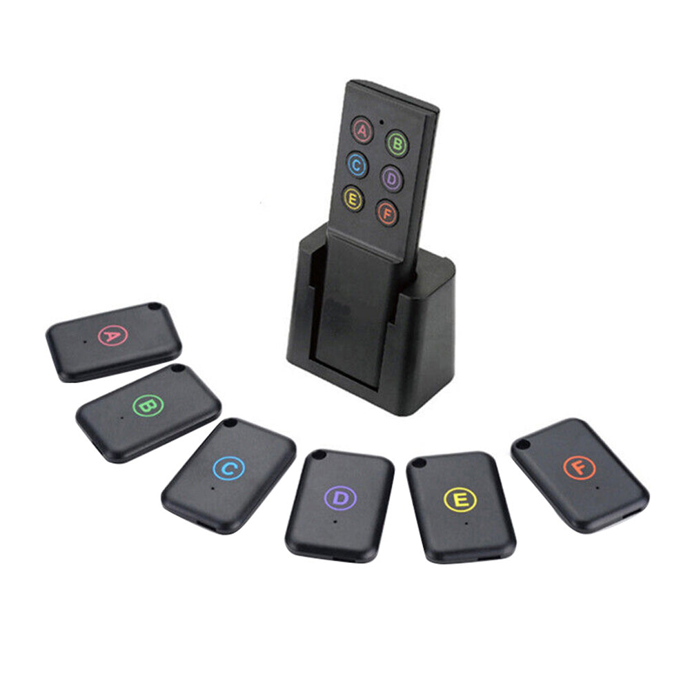 Wireless key finder set showing one black remote transmitter and six small tracker receivers — view 3