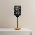Industrial bedside table lamp with metal barrel cage, natural wooden base, and vintage Edison bulb