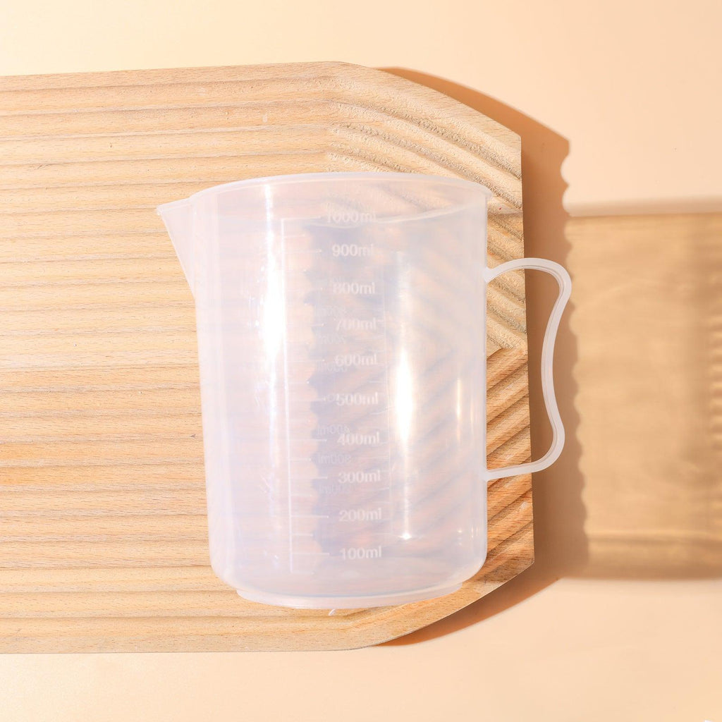 Clear 1000ml measuring cup with precise graduation marks and convenient pour spout for kitchen use