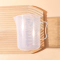 Clear 1000ml measuring cup with precise graduation marks and convenient pour spout for kitchen use
