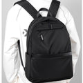 Minimalist black waterproof nylon laptop backpack with zippered pockets for urban commuting and travel