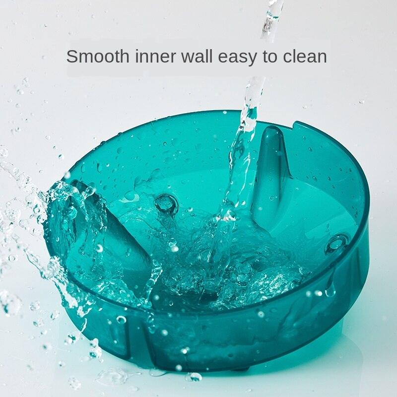 Eco-friendly tilted pet bowl with replaceable bagasse paper inserts in vibrant green and orange. — view 2