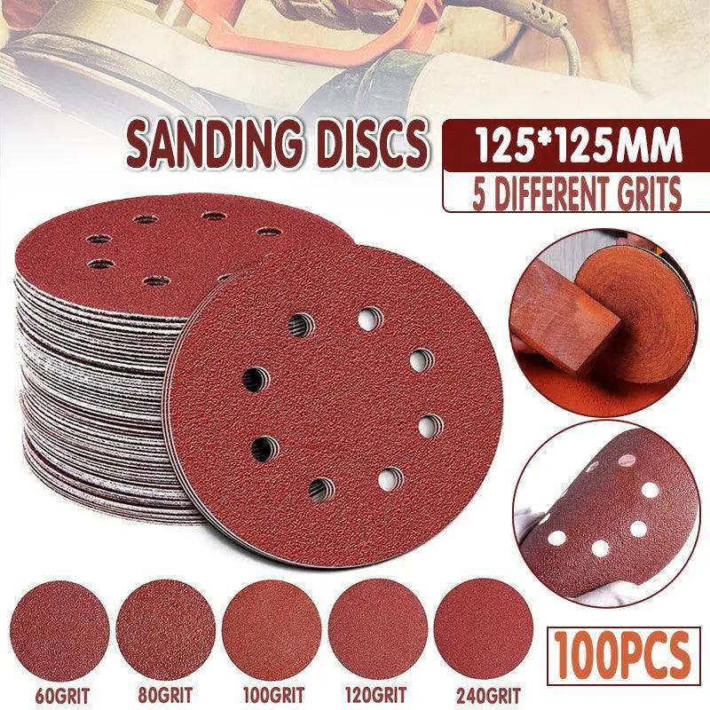 5-inch orbital sanding discs with 8 holes in assorted grits arranged on a flat surface