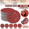 5-inch orbital sanding discs with 8 holes in assorted grits arranged on a flat surface