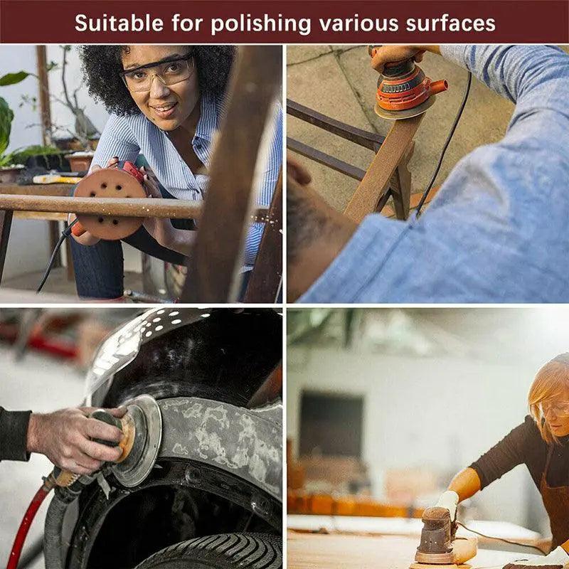 5-inch orbital sanding discs with 8 holes in assorted grits arranged on a flat surface — view 4