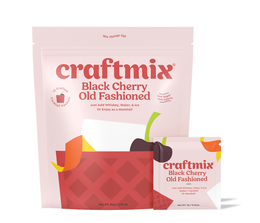 Black cherry old fashioned cocktail mix packet with a dark red drink over ice — view 5