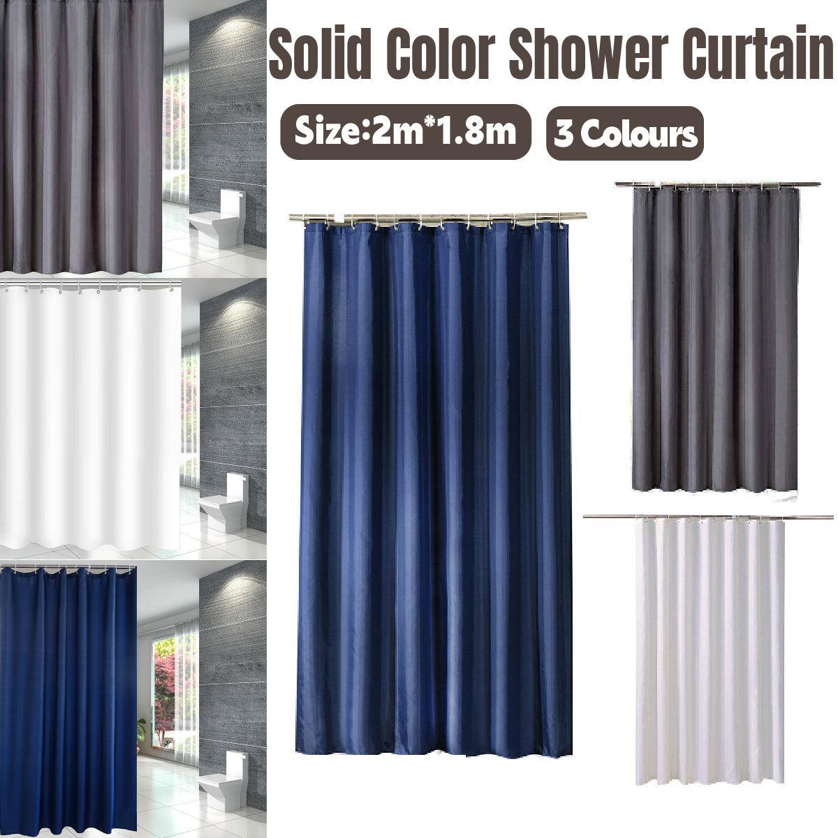 Solid colour waterproof fabric shower curtain in a modern bathroom setting with heavy duty hooks