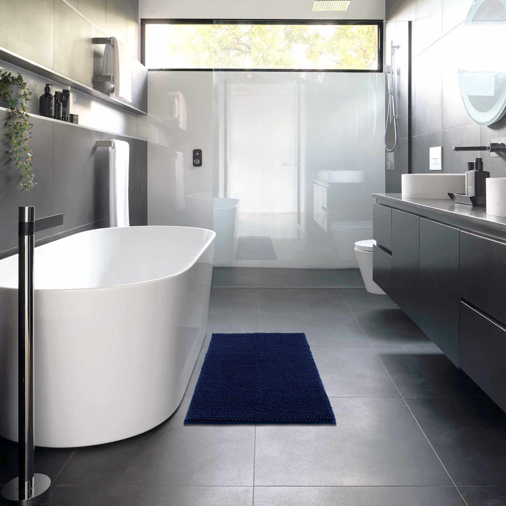 Plush navy blue washable bath mat with thick polyester shag texture on a bathroom floor — view 5