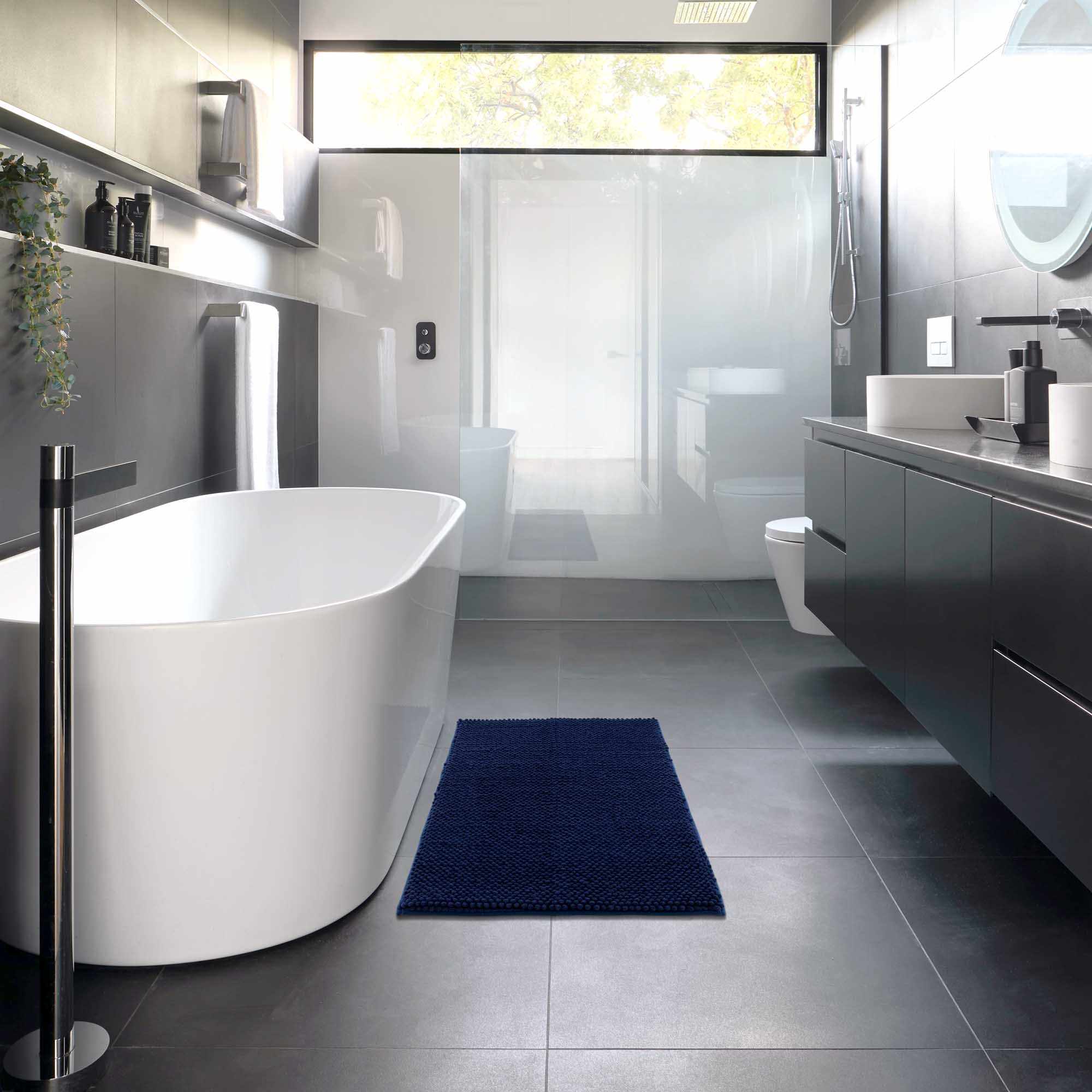 Plush navy blue washable bath mat with thick polyester shag texture on a bathroom floor — view 5
