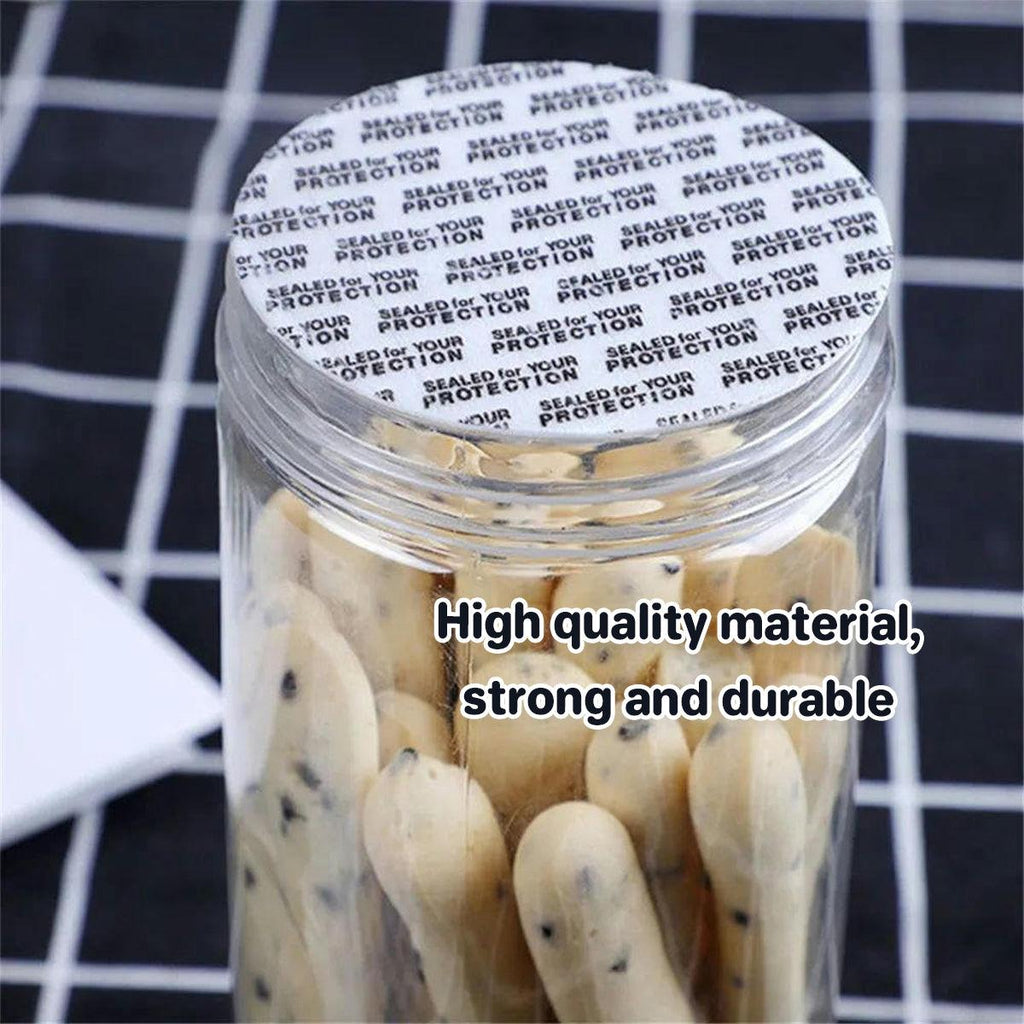 White pressure-sensitive foam bottle cap liners arranged in a neat pile for jar sealing — view 4