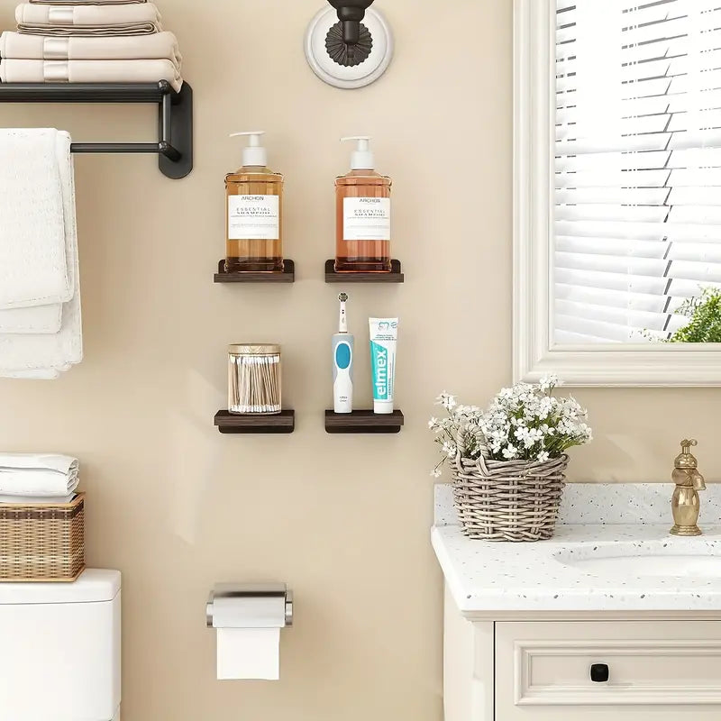Four piece black wooden floating wall shelves displaying small potted plants and books — view 4