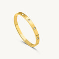 Crystal Love Bangle Bracelet with heart shaped crystal centerpiece and polished metallic adjustable band