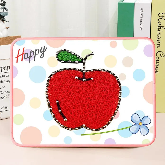 Apple string art kit with colorful threads, metallic pins, wooden base, and a display stand