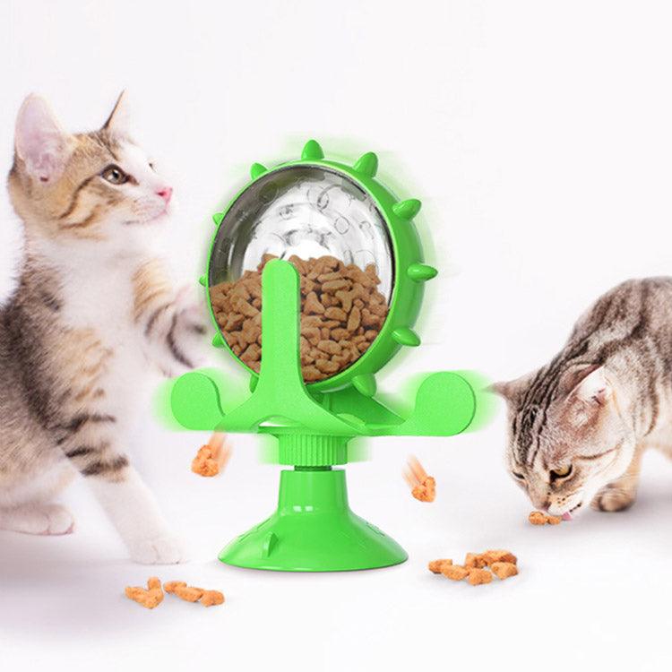 Interactive spinning windmill cat toy with suction cup base and treat dispensing chambers in plastic