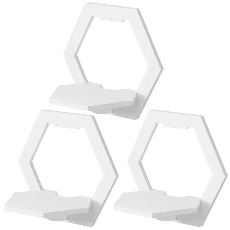 Set of 3 glossy white hexagonal floating wall shelves displaying small plants and picture frames — view 2