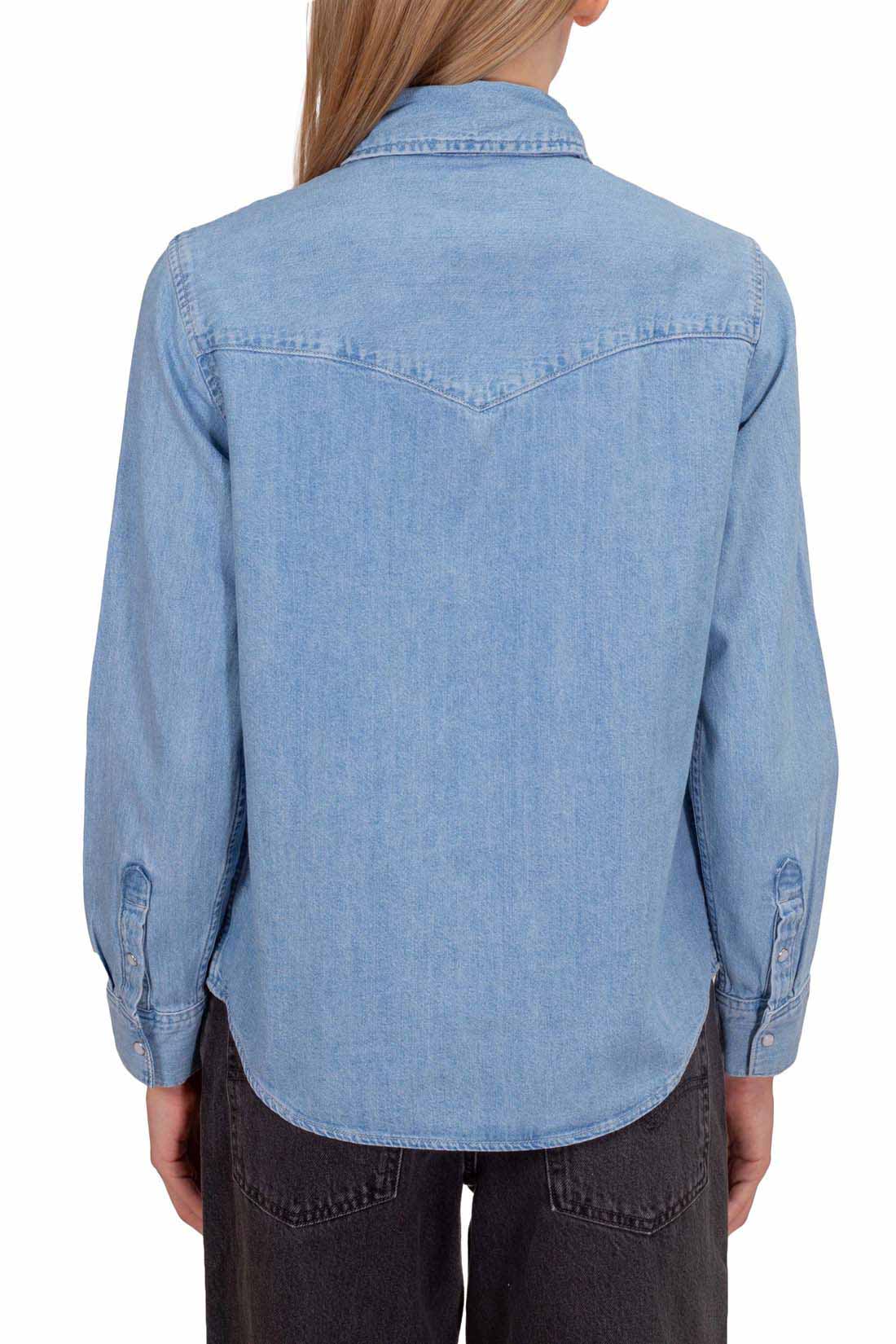 Women's light blue wash denim shirt with snap buttons, long sleeves, and front flap pockets. — view 11