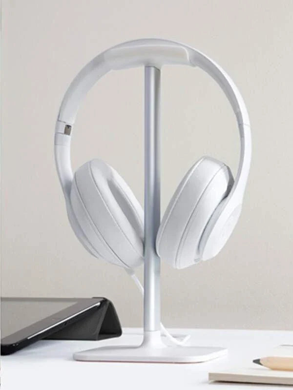Modern white headphone stand with aluminum support bar resting securely on a flat desktop surface — view 4