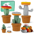 Three handmade amigurumi crochet cacti made from vibrant green yarn and safety eyes