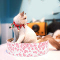 Round corrugated cat scratcher with wooden frame serving as a modern indoor pet lounge