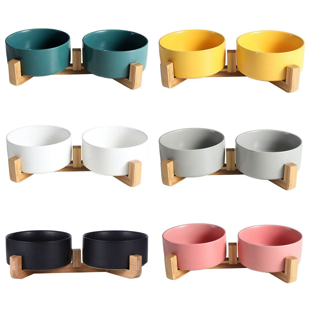 Double ceramic pet feeding bowls on an elevated wooden bamboo stand in stylish modern colors — view 2